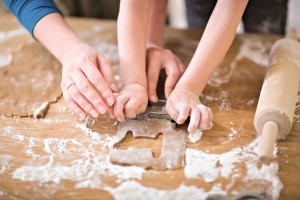 Young mother and son in kitchen making cookies.